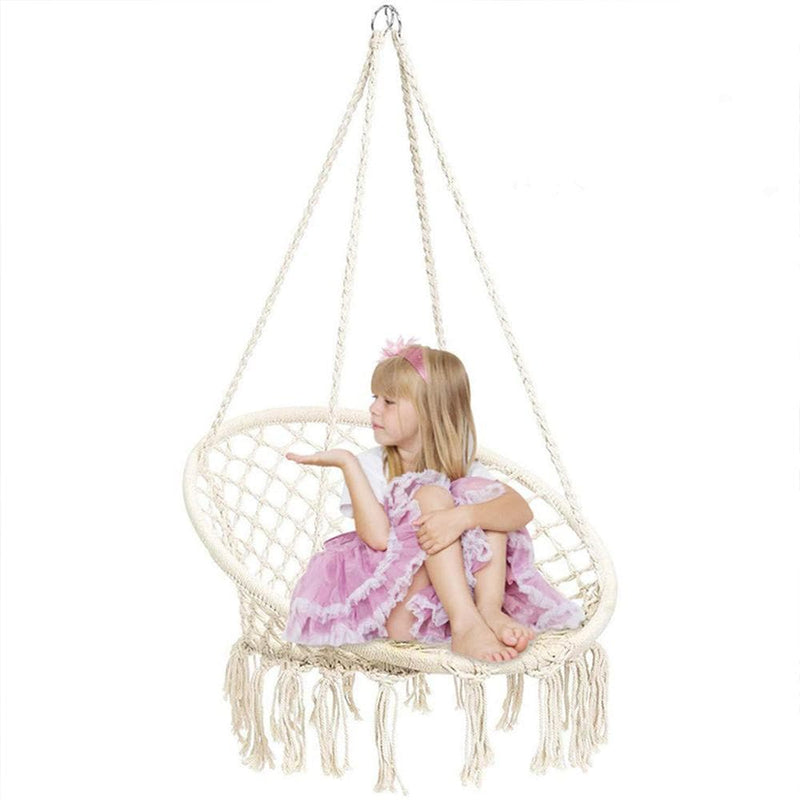 child sits on the hanging hammock swing